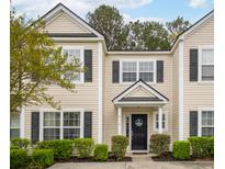 Charming townhome featuring a welcoming entrance, neutral siding, black shutters, and well-maintained landscaping at 9118 Maple Grove Dr, Summerville, SC 29485