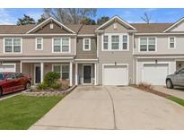 Charming townhome featuring a one-car garage and covered front porch with great curb appeal at 9727 Transplanter Cir, Ladson, SC 29456