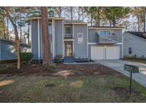 Charming two-story home with light-blue painted wood and double-door garage at 117 Lewisfield Dr, North Charleston, SC 29418