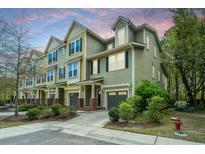 Attractive townhomes featuring varied siding, private garages, and manicured landscaping create curb appeal at 1271 Dingle Rd, Mount Pleasant, SC 29466