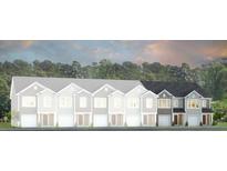 New townhome construction showcasing attached garages and craftsman-style architecture with grey and brown color schemes at 135 Yarrow Way, Moncks Corner, SC 29461