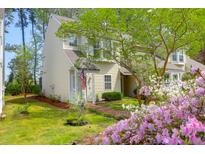 Charming two-story home with an inviting front porch and beautifully landscaped front yard with pink and white flowers at 2 Townpark Ln # D, Charleston, SC 29412