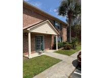 Charming brick home with a covered front porch and well-maintained landscaping at 203 Oakmont Ave # B, Ladson, SC 29456