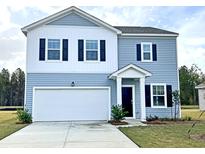 Charming two-story home with blue siding, white accents, and a two-car garage at 700 Pisces Ln, Summerville, SC 29486