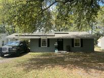 Charming single-story home featuring solar panels and a convenient carport for covered parking at 1206 Hawthorne Rd, Hanahan, SC 29410