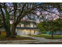 Charming two-story home with a well-manicured lawn and mature trees at 1502 Thoroughbred Blvd, Johns Island, SC 29455