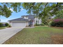 Charming two-story home with a landscaped yard, mature trees, and a welcoming front entrance at 2345 Waring Hall Ln, Charleston, SC 29414