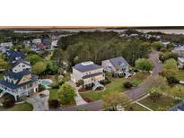 A charming home featuring a private pool, lush greenery, and beautiful architectural details in a desirable neighborhood at 2504 Ballast Pt, Mount Pleasant, SC 29466
