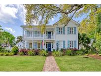 Charming two-story home with a brick pathway leading to a welcoming front porch at 304 Bank St, Mount Pleasant, SC 29464