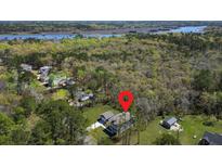 Beautiful aerial view of home, garage, and wooded lot on the water in a desirable coastal neighborhood at 4235 Royal Harbor Rd, Hollywood, SC 29449