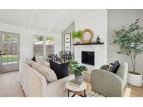 Bright living room with whitewashed brick fireplace, beamed ceiling, and stylish decor at 5573 Betty Ct, North Charleston, SC 29418