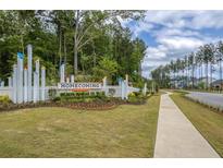 Welcome to Homecoming: picturesque community entrance with attractive landscaping and sidewalk at 1014 Marsh Harrier Dr # Cc3-1-5, Ravenel, SC 29470