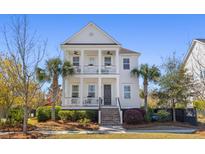 Charming two-story home boasting double porches, columns, and lush landscaping, offering classic curb appeal at 1555 Willtown St, Daniel Island, SC 29492