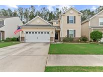 Charming two-story home with an attached two-car garage and a well-maintained front yard at 215 Overcup Loop, Summerville, SC 29486