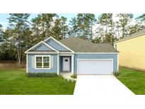 Charming one-story home with blue siding, white trim, and a well-manicured front lawn, perfect for first-time buyers at 2243 Macallan Blvd, Ravenel, SC 29470