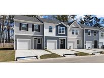 New townhomes with attached garages and varied color schemes offer modern living at 2602 Scarlett Maple St, Summerville, SC 29486