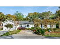 Charming one-story home with white exterior and well-manicured front yard landscaping at 3 Lauden Blvd, Isle of Palms, SC 29451