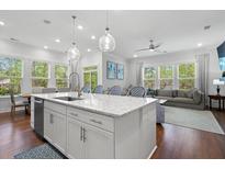 Bright kitchen with quartz counters, large windows, pendant lights, stainless appliances, and adjacent sitting and living areas at 3010 Emma Ln, Mount Pleasant, SC 29466