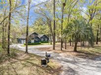 Charming two-story home with mature trees, lovely landscaping, and a long driveway at 306 Teakwood Dr, Walterboro, SC 29488