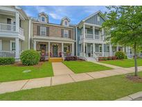 Charming multi-colored two-story townhomes with inviting front porches and well manicured lawns at 3466 Yarmouth Dr, Mount Pleasant, SC 29466