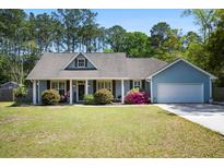 Charming single-story home featuring a well-manicured lawn and beautiful landscaping in a desirable location at 4429 Highway 162, Hollywood, SC 29449