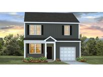 Charming two-story home with black siding, white trim and a well-manicured lawn at 5520 Bowmore Blvd, Ravenel, SC 29470