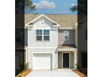 Charming two-story home features a light gray exterior, a single-car garage and a concrete driveway at 122 Haventree Ct, Summerville, SC 29486