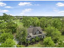 Stunning exterior view of a beautifully landscaped home surrounded by lush greenery and a golf course backdrop at 126 Balfour Dr, Charleston, SC 29492