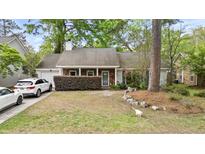 Charming single-story home with brick accents, mature landscaping, and a well-manicured front yard at 181 Commons Way, Goose Creek, SC 29445