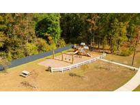 Community playground featuring swings, slides, and a picnic table, all surrounded by a wooded area at 181 Morning View Way, Moncks Corner, SC 29461