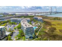 Stunning aerial view of modern apartment buildings with waterfront views and the Ravenel Bridge in the background at 341 Cooper River Dr, Mount Pleasant, SC 29464