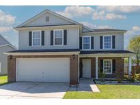 Charming two-story home featuring brick accents, a well-maintained lawn, and an attached two-car garage at 5007 Ballantine Dr, Summerville, SC 29485