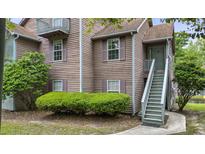 Charming condo shows inviting exterior with lush landscaping and private entrance at 7920 Parklane Ct # 608, North Charleston, SC 29418