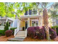Charming two-story home with a well-manicured lawn, a welcoming porch, and a beautiful palm tree in the front yard at 1243 Appling Dr, Mount Pleasant, SC 29464