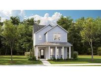 Charming two-story home with light blue siding, covered front porch, and well-manicured lawn at 1431 Clay Field Trl, Summerville, SC 29485