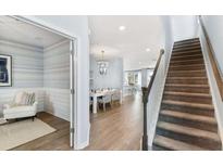 Inviting entryway featuring an adjacent seating area, elegant chandelier, and staircase at 151 Threaded Fern St, Summerville, SC 29485