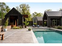 Stunning pool and outdoor lounge area of this modern home, perfect for relaxation and entertaining at 2885 Plow Ground Rd, Johns Island, SC 29455