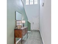 Welcoming foyer with stylish console table, mirror, and modern decor, illuminated by natural light from transom windows at 302 Fox Gap Rd, Summerville, SC 29486