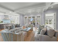 Bright living room featuring stylish furnishings and French doors leading to the outdoor space at 66 New Settlement Rd, Kiawah Island, SC 29455