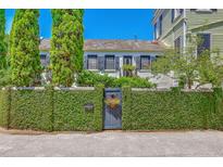 Charming home exterior with a lush, ivy-covered wall and garden gate at 95 Ashley Ave # D, Charleston, SC 29401