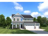 Charming two-story home featuring a spacious three-car garage and well-manicured lawn at 1015 Lacebark Dr, Ridgeville, SC 29472