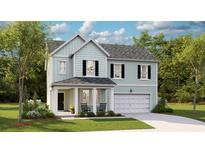 Charming two-story home with light blue siding, a welcoming front porch and attached two-car garage at 1055 Tea Time Dr, Summerville, SC 29485