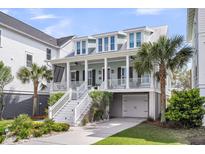 Charming two-story home features a welcoming front porch, white railing, and manicured landscaping at 1063 Hills Plantation Dr, Charleston, SC 29412