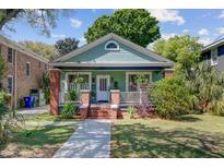 Charming craftsman home with a welcoming front porch and lush landscaping at 1157 King St, Charleston, SC 29403