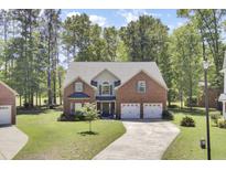 Charming two-story brick home with a well-manicured lawn and a two-car garage at 123 Dasharon Ln, Goose Creek, SC 29445