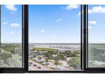 Beautiful harbor view from the window featuring blue skies, trees, and boats at 14 Lockwood Dr # 6E, Charleston, SC 29401