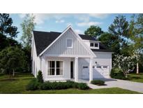 Charming exterior elevation showcases a two-car garage, covered porch, and manicured lawn at 225 Denham St, Summerville, SC 29486