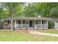 Charming single-story home with covered front porch and manicured lawn in a wooded neighborhood at 306 Fairlawn Drive, Moncks Corner, SC 29461