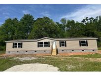 Charming single-story home with neutral siding, black shutters, and inviting front steps at 320 Bedford Rd, Cross, SC 29436