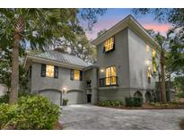 Stunning two-story home with lush landscaping, garage, and inviting curb appeal at 410 Ocean Oaks Ct, Kiawah Island, SC 29455
